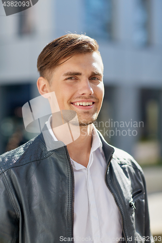 Image of portrait of young man in leather jacket outdoors