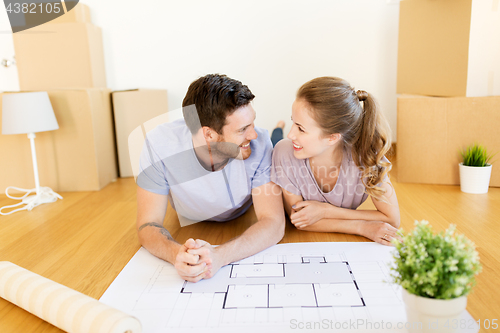 Image of couple with boxes and blueprint moving to new home