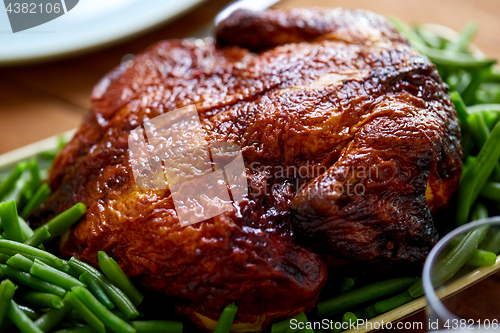 Image of close up of roast chicken with green beans