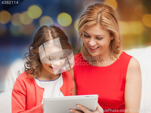 Image of mother and daughter with tablet pc at home