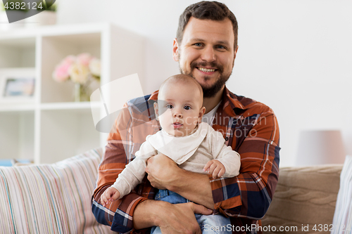 Image of happy father with little baby boy at home