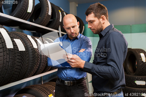 Image of customer and salesman at car service or auto store