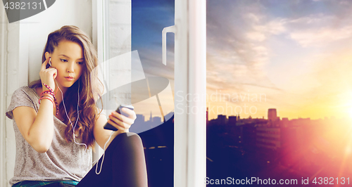 Image of teenage girl with smartphone and earphones