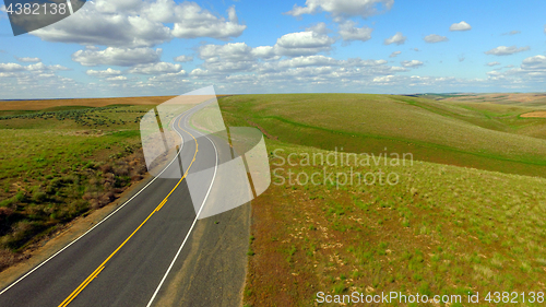 Image of Floating White Clouds Blue Sky Open S Curve Washington Highway