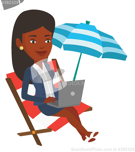 Image of Businesswoman working on laptop at the beach.