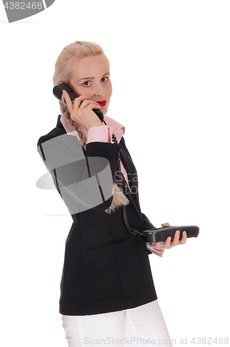 Image of Business woman talking on an old phone