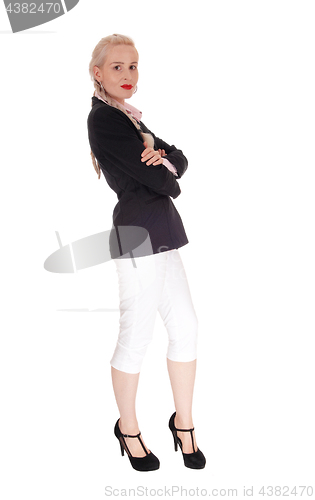 Image of Business woman standing in jacked and white pants