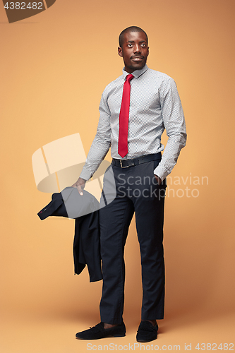 Image of cheerful african businessman looking at the camera