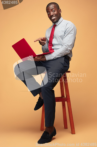 Image of Handsome Afro American man using a laptop