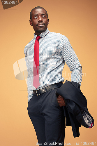 Image of cheerful african businessman looking at the camera