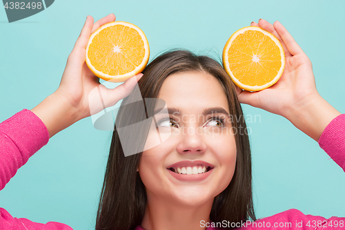 Image of Beautiful woman\'s face with juicy orange