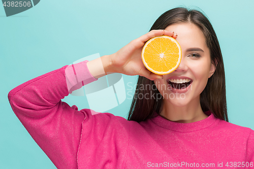 Image of Beautiful woman\'s face with juicy orange