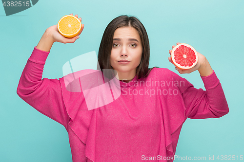 Image of Beautiful woman\'s face with juicy orange