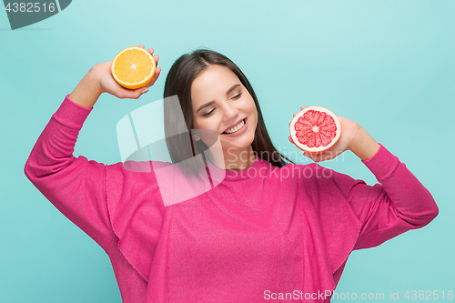 Image of Beautiful woman\'s face with juicy orange