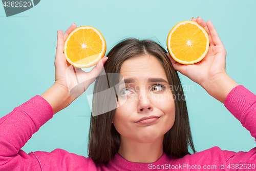 Image of Beautiful woman\'s face with juicy orange