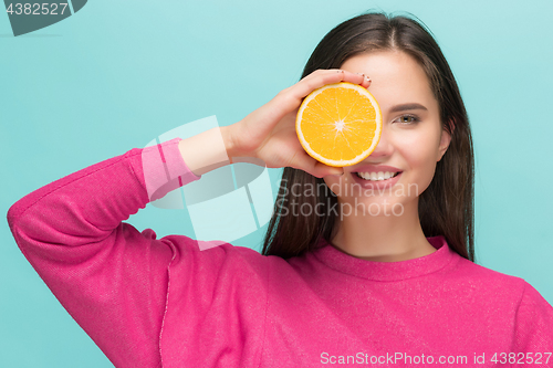 Image of Beautiful woman\'s face with juicy orange