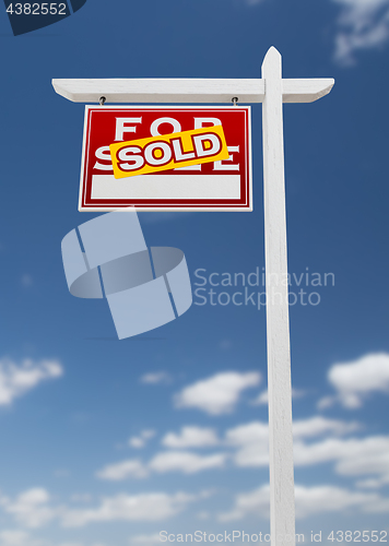 Image of Left Facing Sold For Sale Real Estate Sign on a Blue Sky with Cl