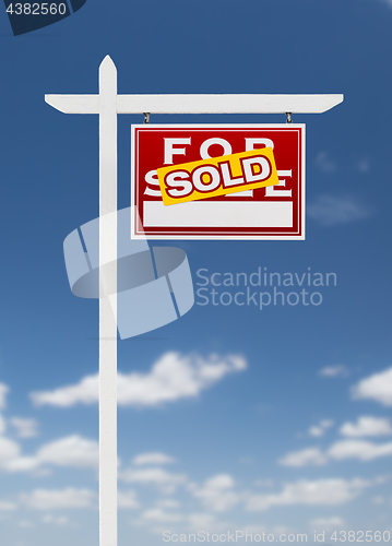 Image of Right Facing Sold For Sale Real Estate Sign on a Blue Sky with C