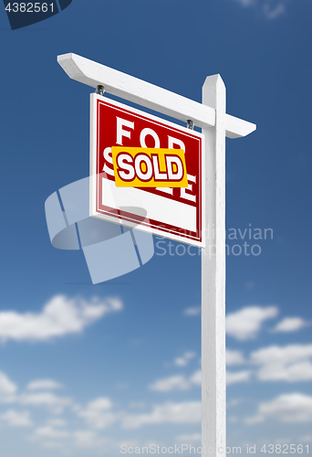 Image of Left Facing Sold For Sale Real Estate Sign on a Blue Sky with Cl