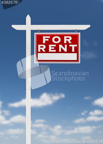 Image of Right Facing For Rent Real Estate Sign on a Blue Sky with Clouds