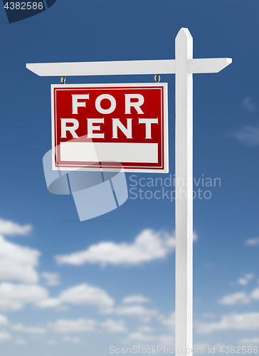 Image of Left Facing For Rent Real Estate Sign on a Blue Sky with Clouds.
