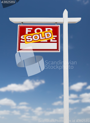 Image of Left Facing Sold For Sale Real Estate Sign on a Blue Sky with Cl