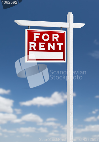 Image of Left Facing For Rent Real Estate Sign on a Blue Sky with Clouds.