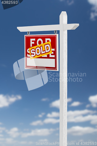 Image of Left Facing Sold For Sale Real Estate Sign on a Blue Sky with Cl