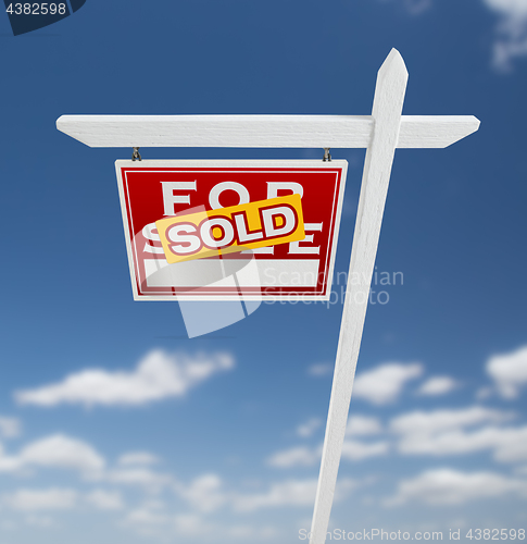 Image of Left Facing Sold For Sale Real Estate Sign on a Blue Sky with Cl