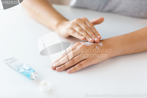 Image of close up of hands with cream or therapeutic salve