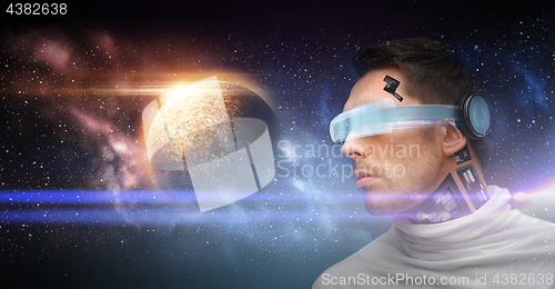 Image of male robot in 3d glasses and sensors over space