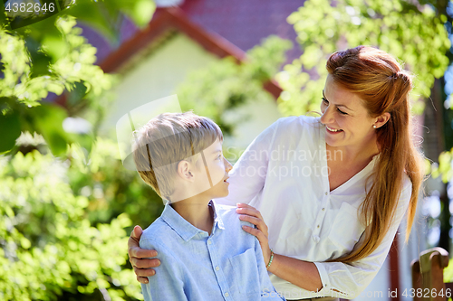 Image of happy mother and son at summer garden