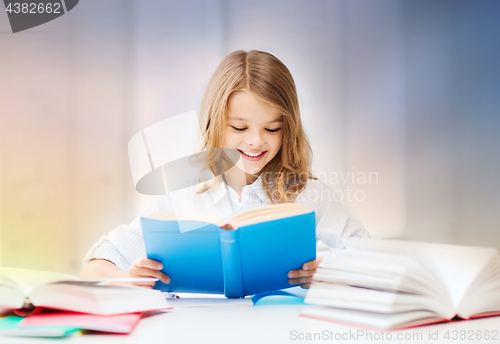 Image of happy smiling student girl reading book