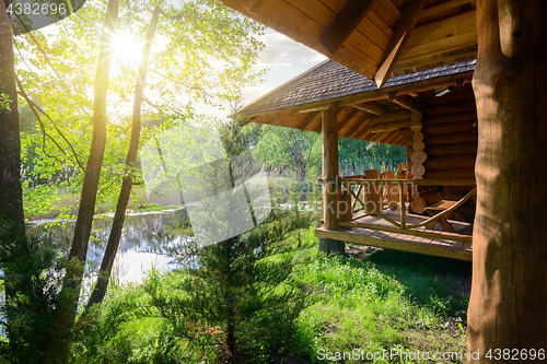 Image of Wooden house and river