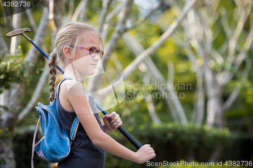 Image of Happy little girl  playing mini golf.