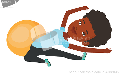 Image of Young woman exercising with fitball.