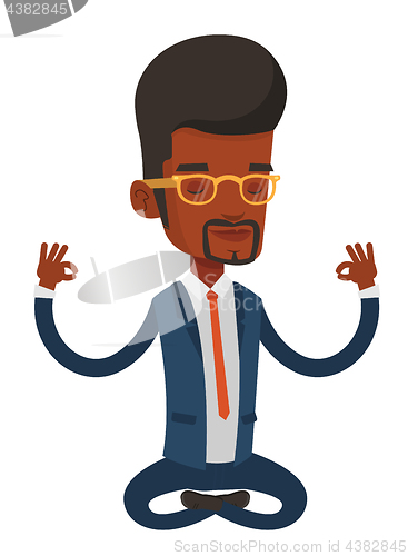 Image of Business man meditating in lotus position.