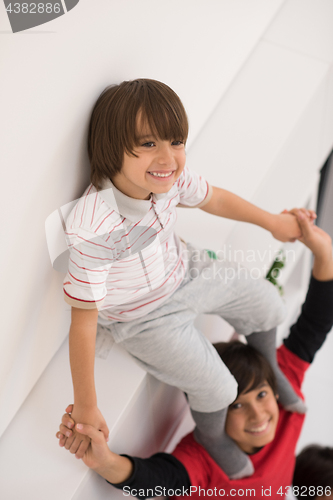 Image of young boys posing line up piggyback top view