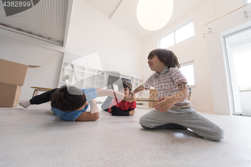 Image of young boys having fun on the floor