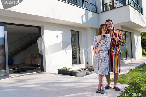Image of Young beautiful couple in bathrobes