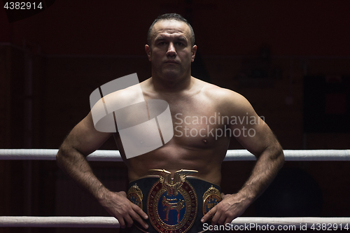 Image of kick boxer with his championship belt