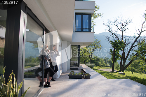 Image of couple enjoying on the door of their luxury home villa