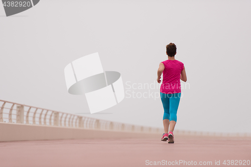 Image of woman busy running on the promenade