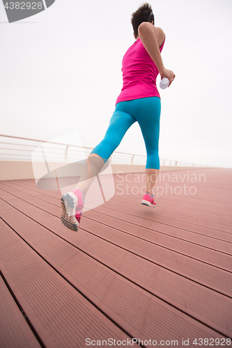 Image of woman busy running on the promenade