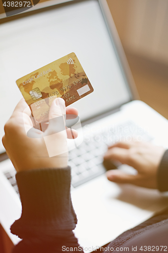 Image of Woman using credit card for online purchase