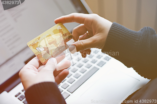 Image of Woman using credit card for online purchase