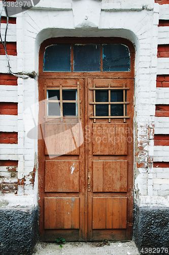 Image of Wooden doorway in brick wall