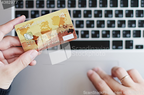 Image of Woman using credit card for online purchase