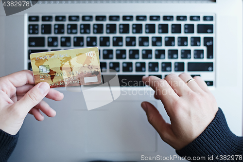 Image of Woman using credit card for online purchase