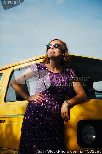 Image of Dreaming girl leaning on van